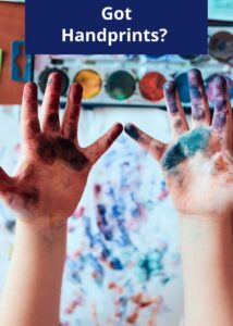 Childs hands covered in paint with the caption Got Handprints